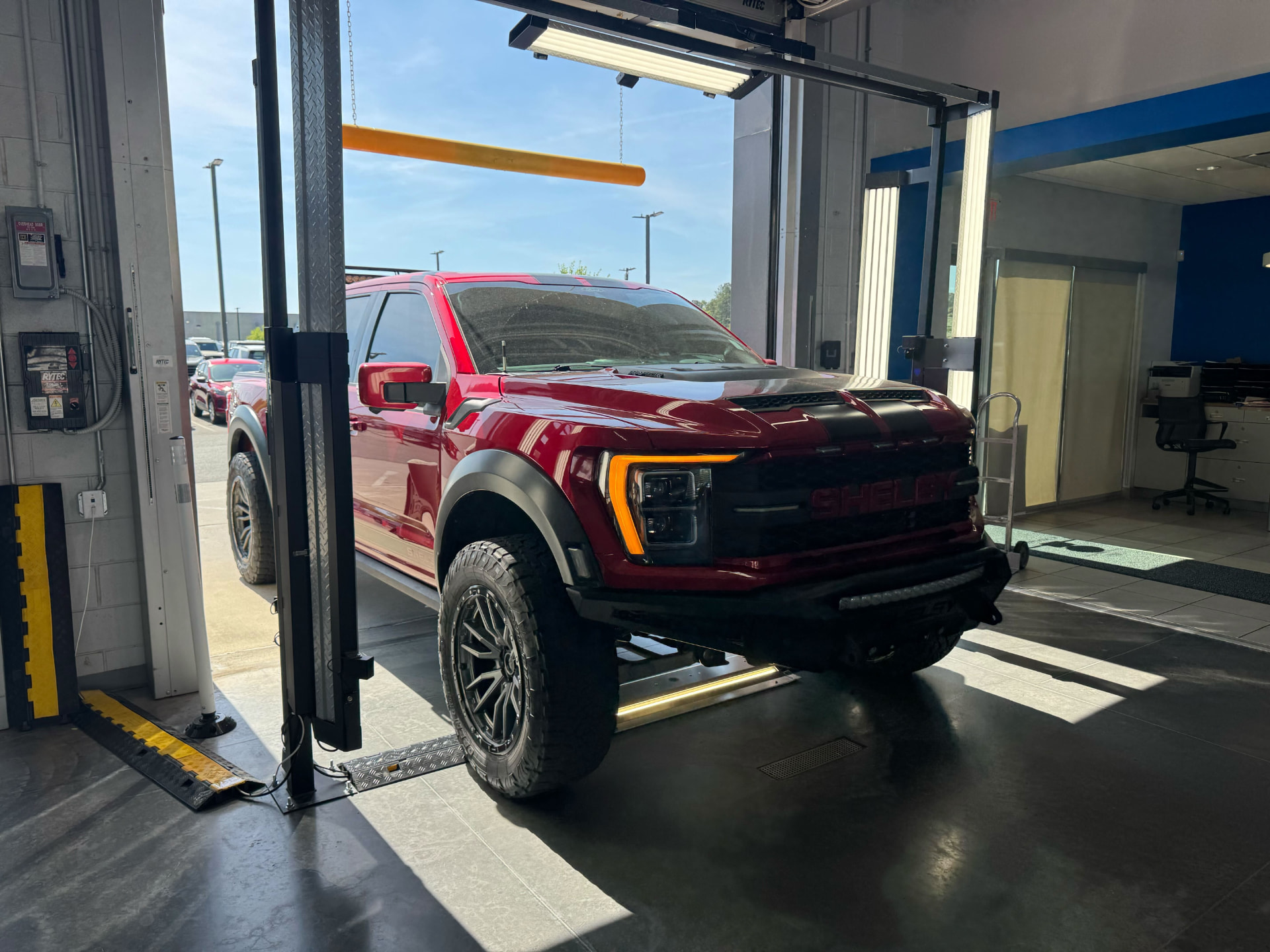 AI 360° vehicle scanner capturing a car as it enters the service drive